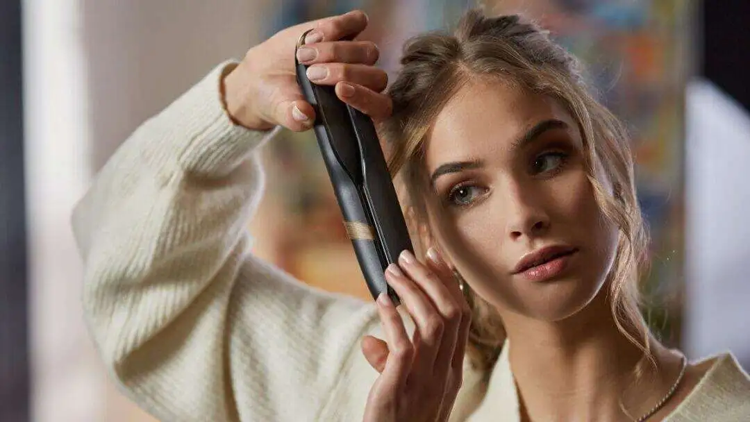 7 Best Cordless Hair Straighteners to Take on Travel - Ghd unplugged A blonde hair women using Ghd Unplugged cordless hair straightener